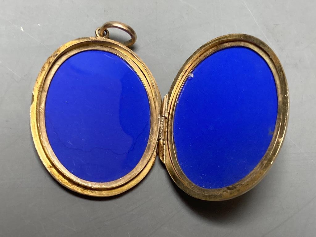 A 1960's engraved 9ct gold mounted oval pendant locket